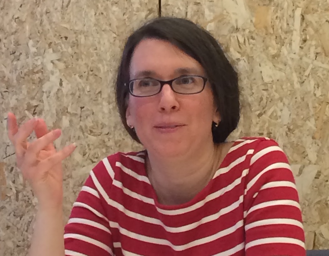 Debbie Finkelstein speaking with a microphone